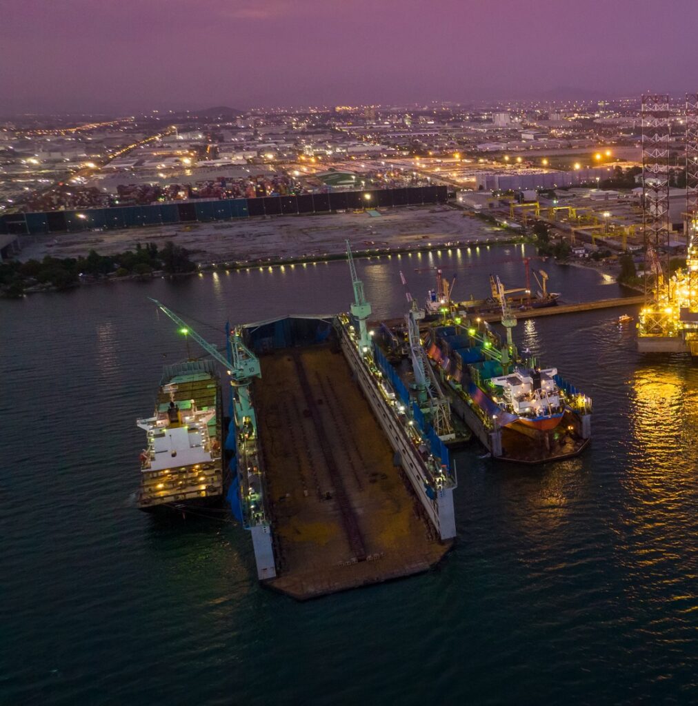 Dry dock or Floating dock Shipyard at night for repare and maintenance cargo container ship service