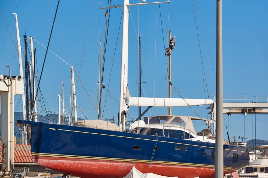 Sailboat on an outdoor shipyard. Nautical maintenance industry. Repair